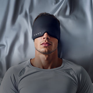 Man Using TRNR Recovery Mask to Relax While Lying Down