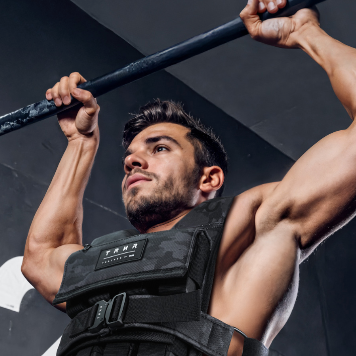 Man on A Pull-Up Bar Wearing the TRNR Power Weight Vest with Booster Pack