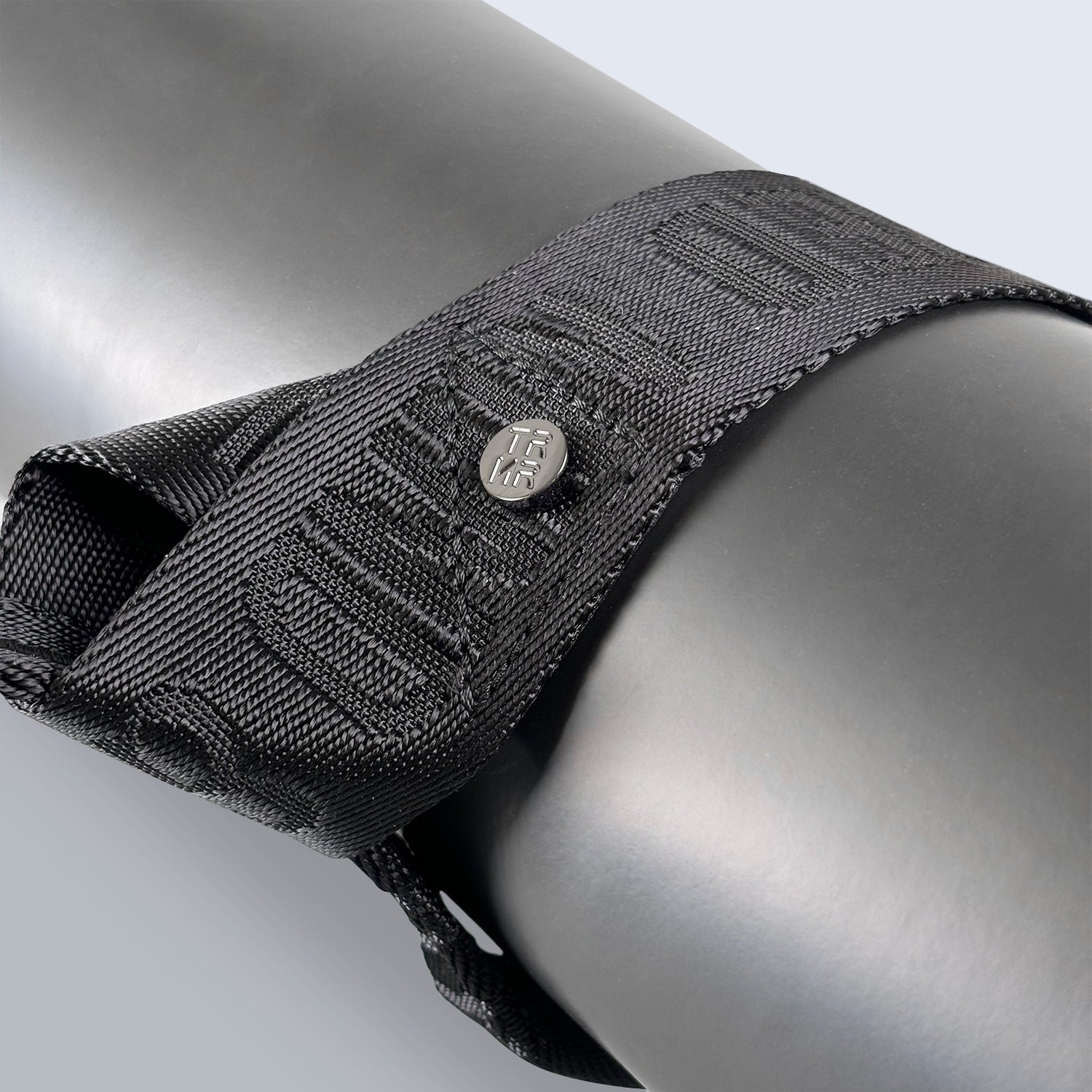 Close-Up of the Black TRNR Mat Carry Strap Showcasing Mantra and Logo