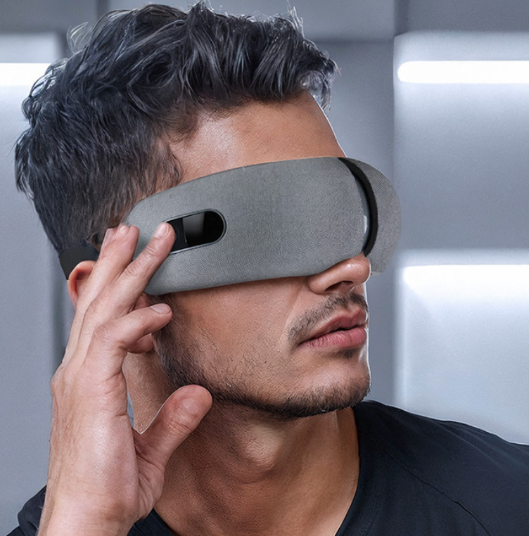 Man wearing a futuristic gray eye mask against a neutral background