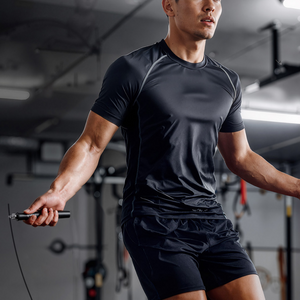 Man exercising with TRNR skipping rope in a gym setting