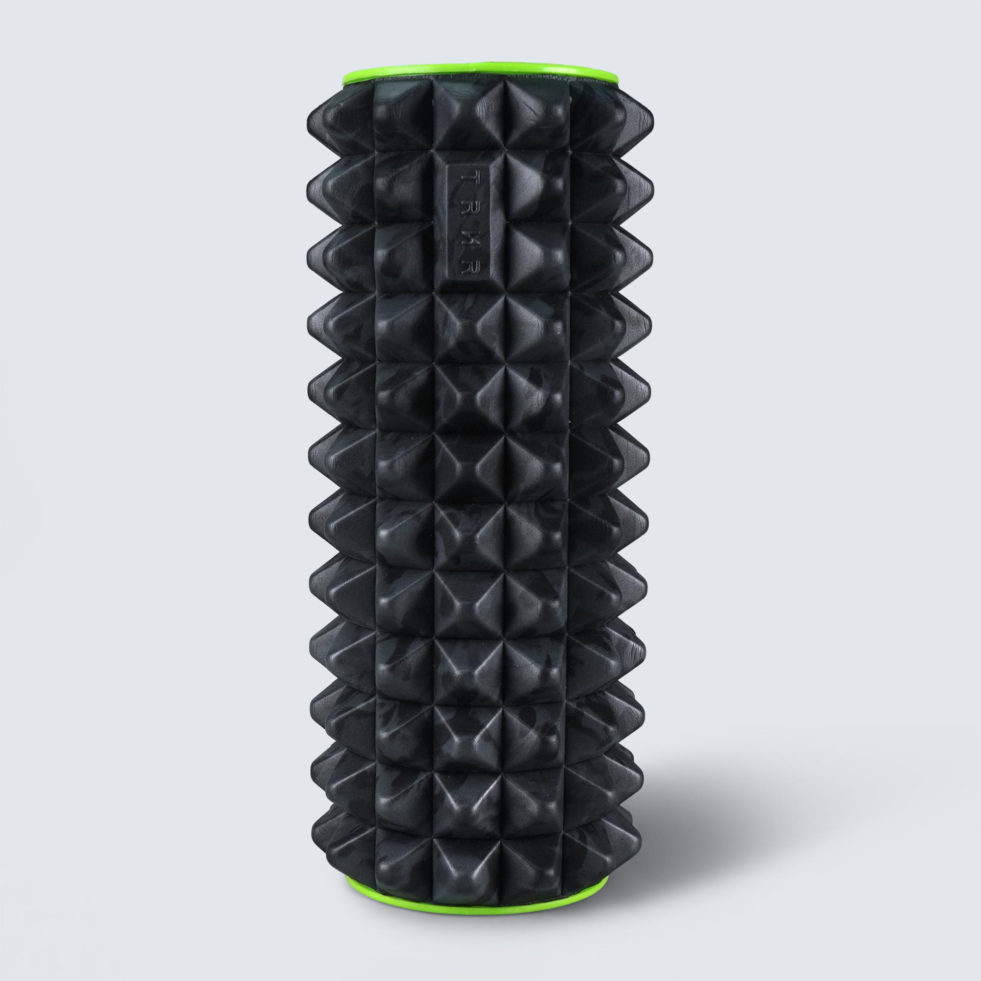 TRNR Black textured foam roller with green accents on a light gray background